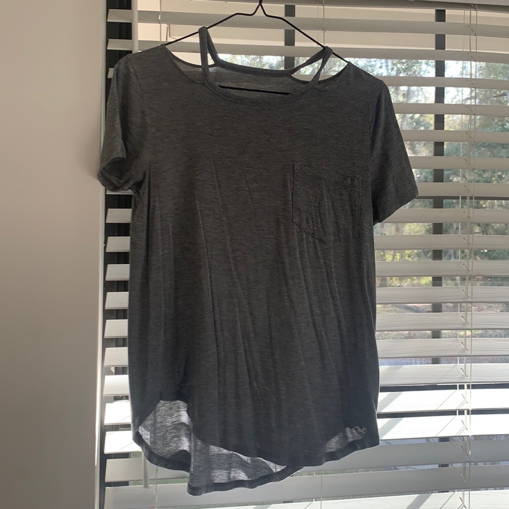 A gray basic short sleeve T-shirt with openings at the top and a pocket